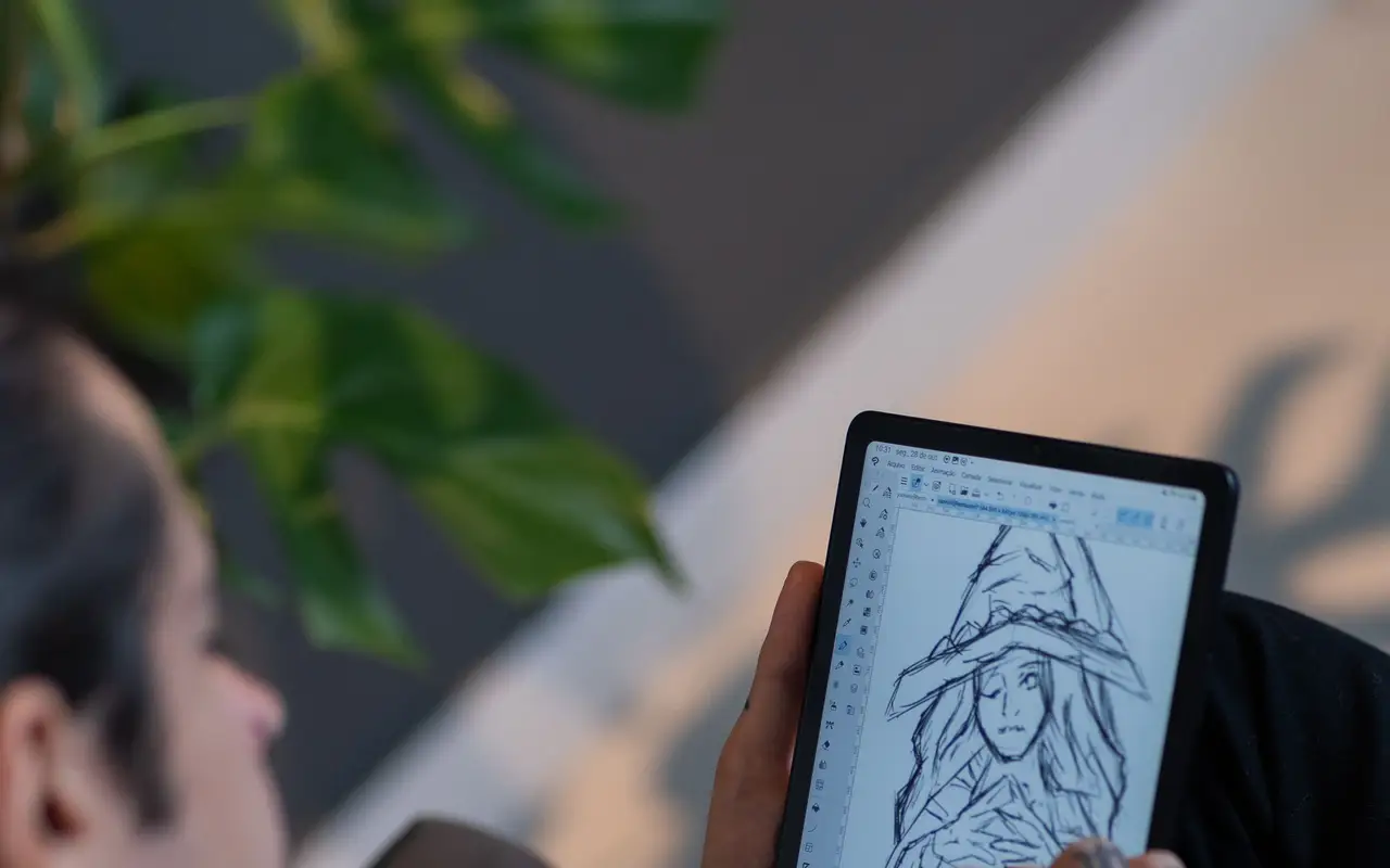 Artist sketching a witch character on a digital tablet