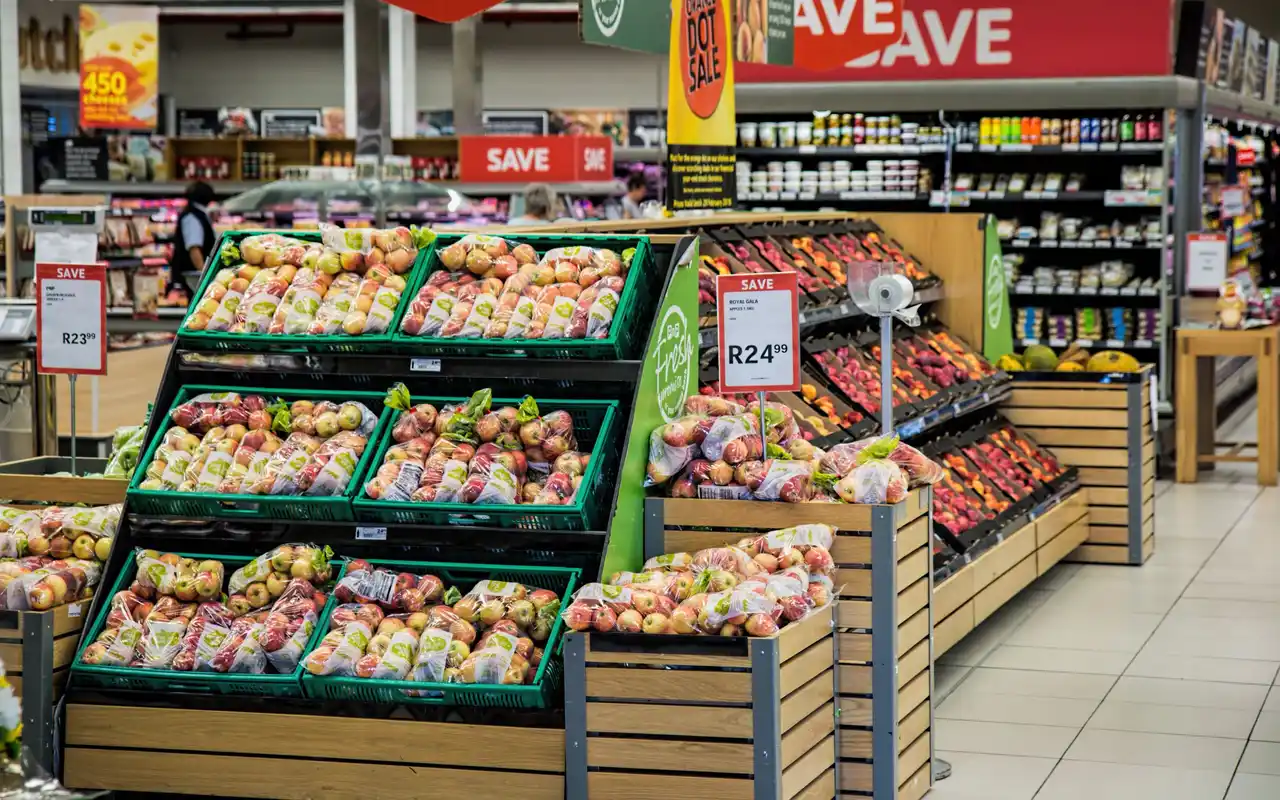 Produce aisle with apples and sale signs
