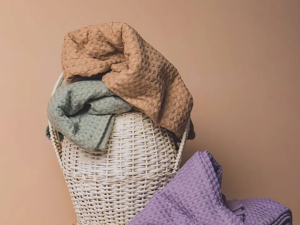 Handwoven towels folded in a wicker basket