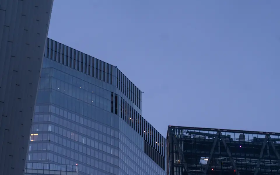 Glass office towers rising against a clear sky in London