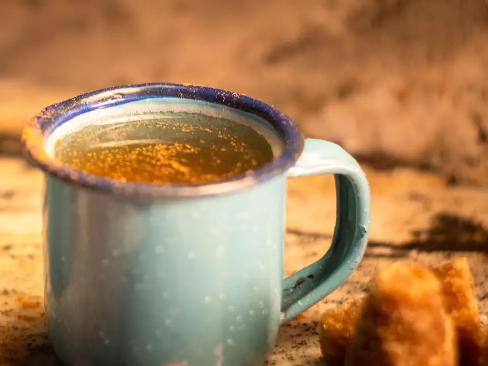 An enamel mug on a wooden table