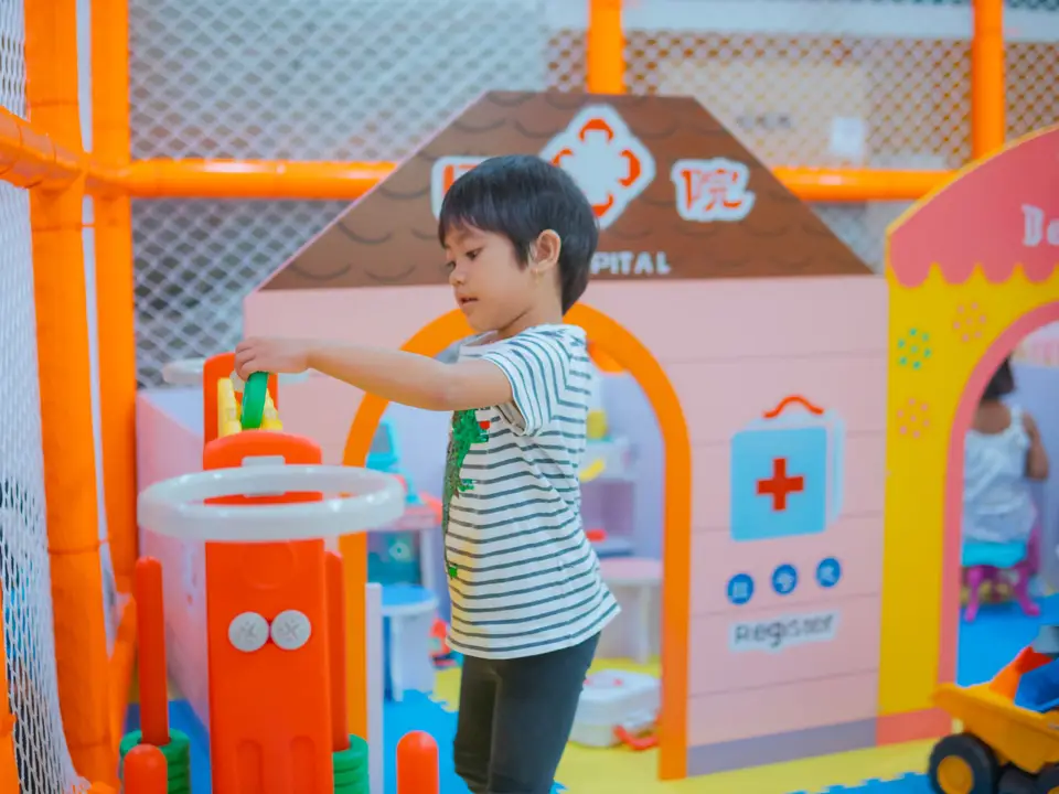 Child playing in a colorful kindergarten classroom