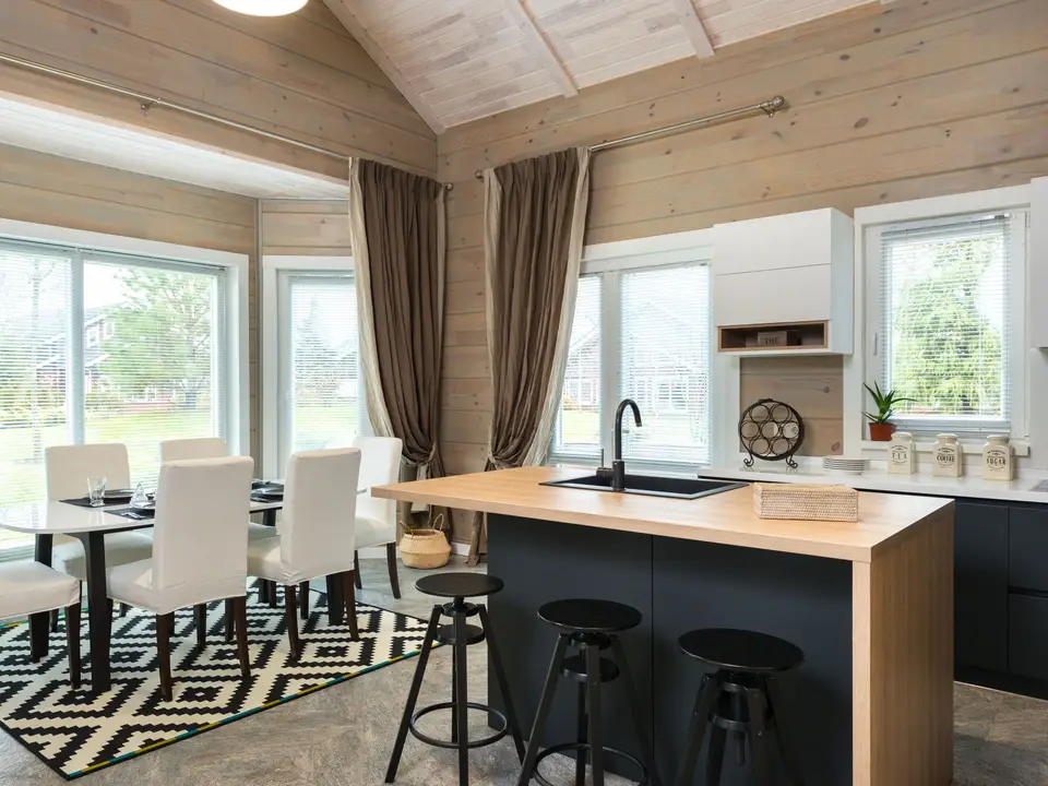 Flat-panel cabinets in warm gray with matte black fixtures