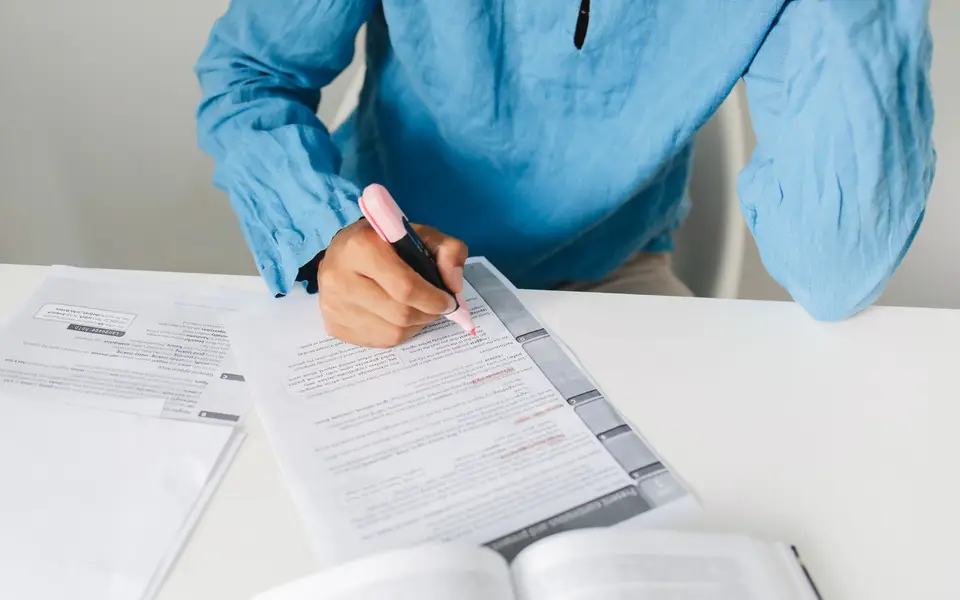 Hands highlighting easement notes on a title commitment