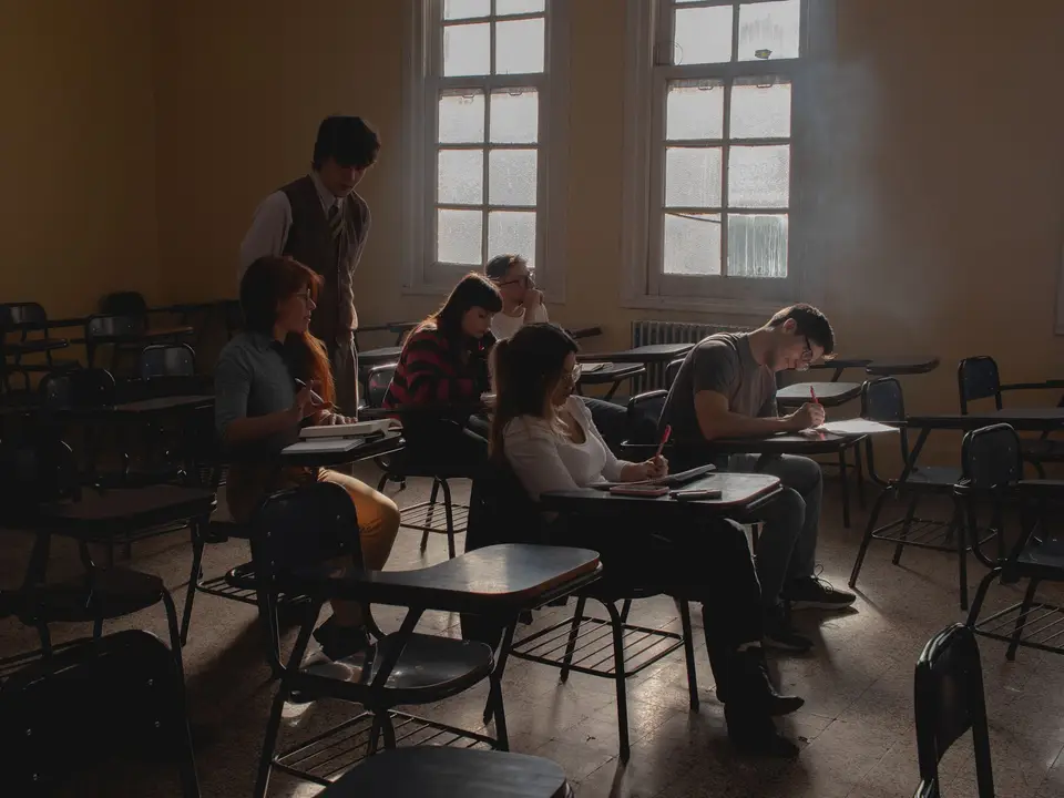 Students studying in a dimly lit classroom