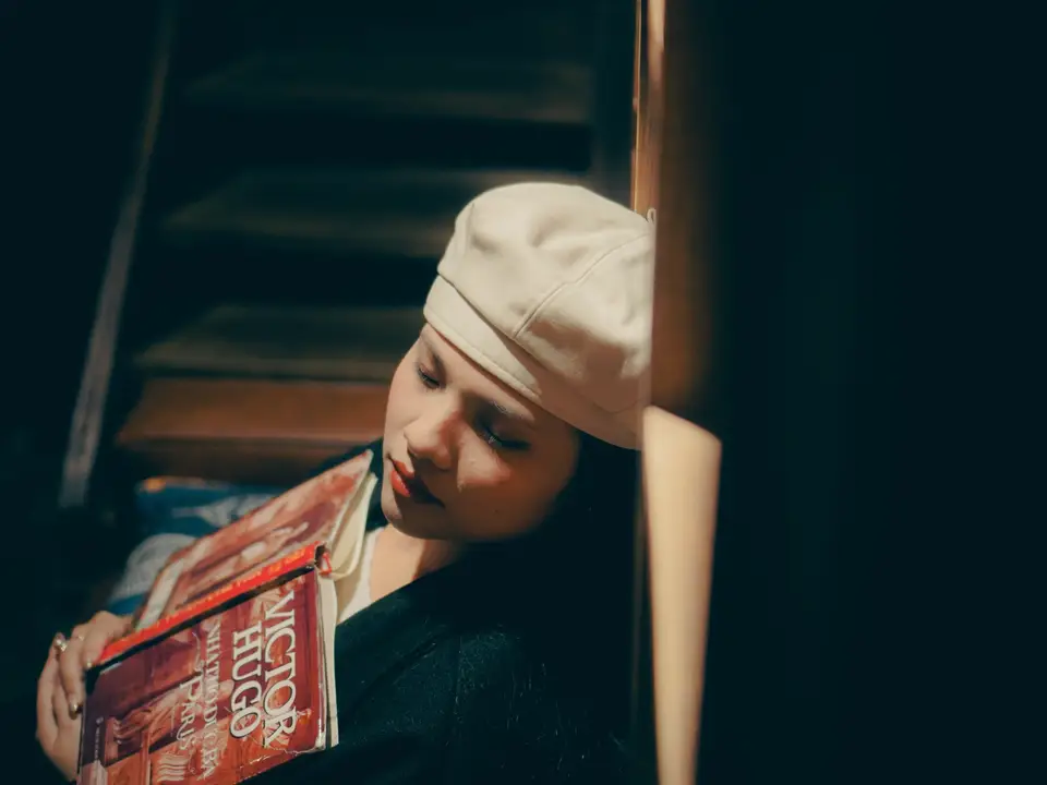 Woman with a beret holding Victor Hugo books