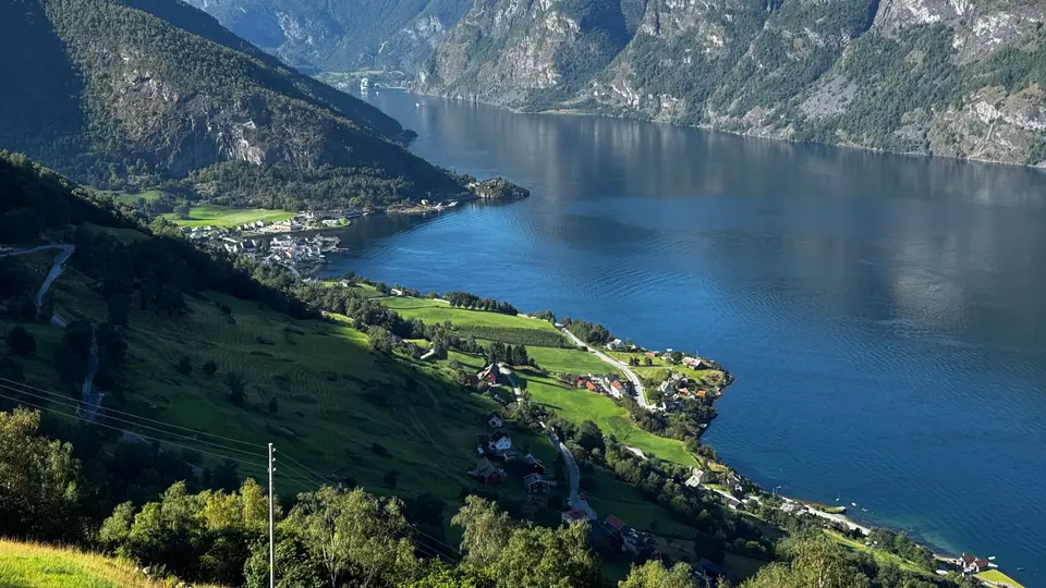 Hikers on a trail above a fjord