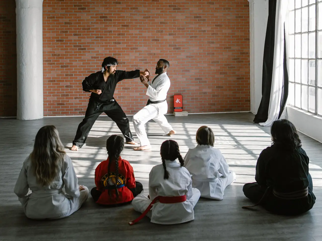 Martial artists practicing kata in a dojo