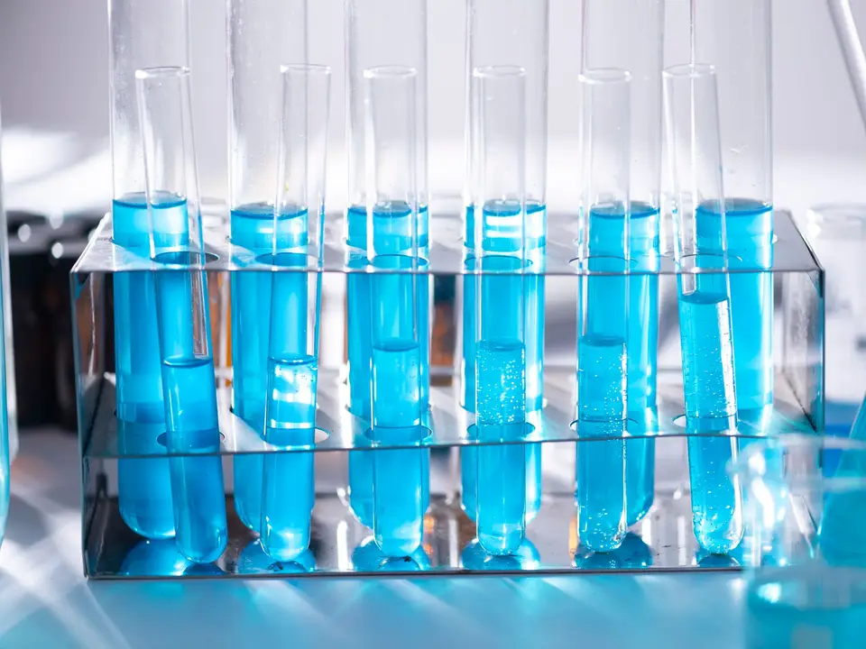 Microscope and test tubes on lab bench