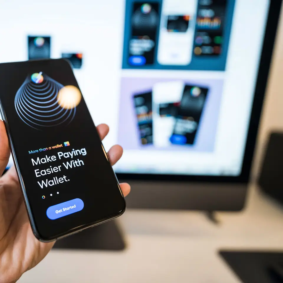 Hand holding smartphone displaying a digital wallet app interface