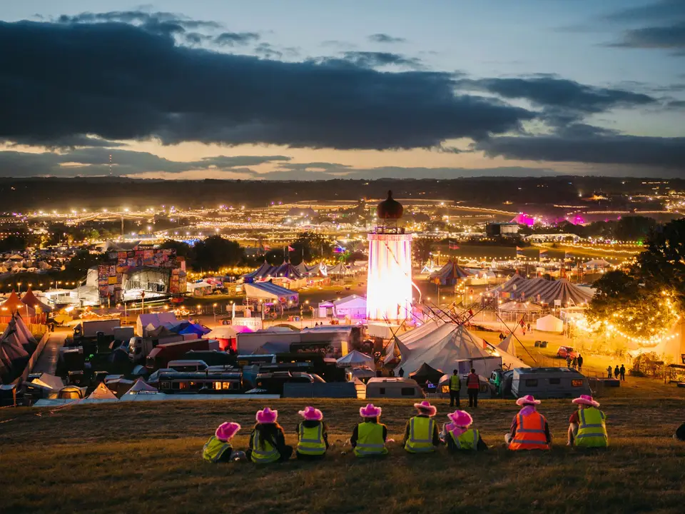 Tents glowing on a field at night