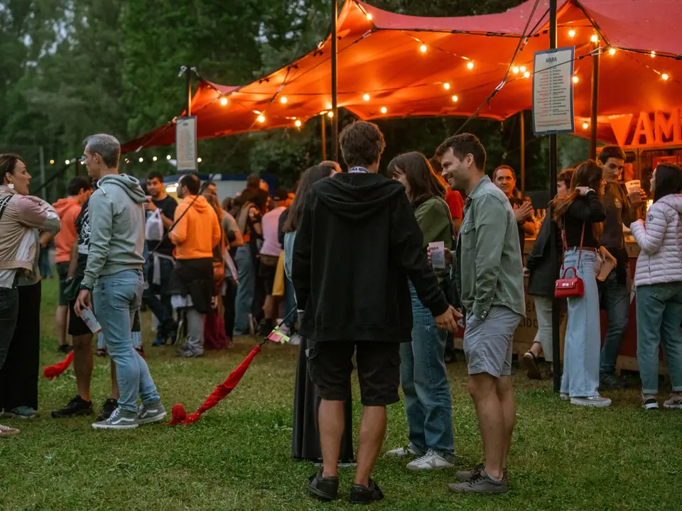 People under a tent of string lights