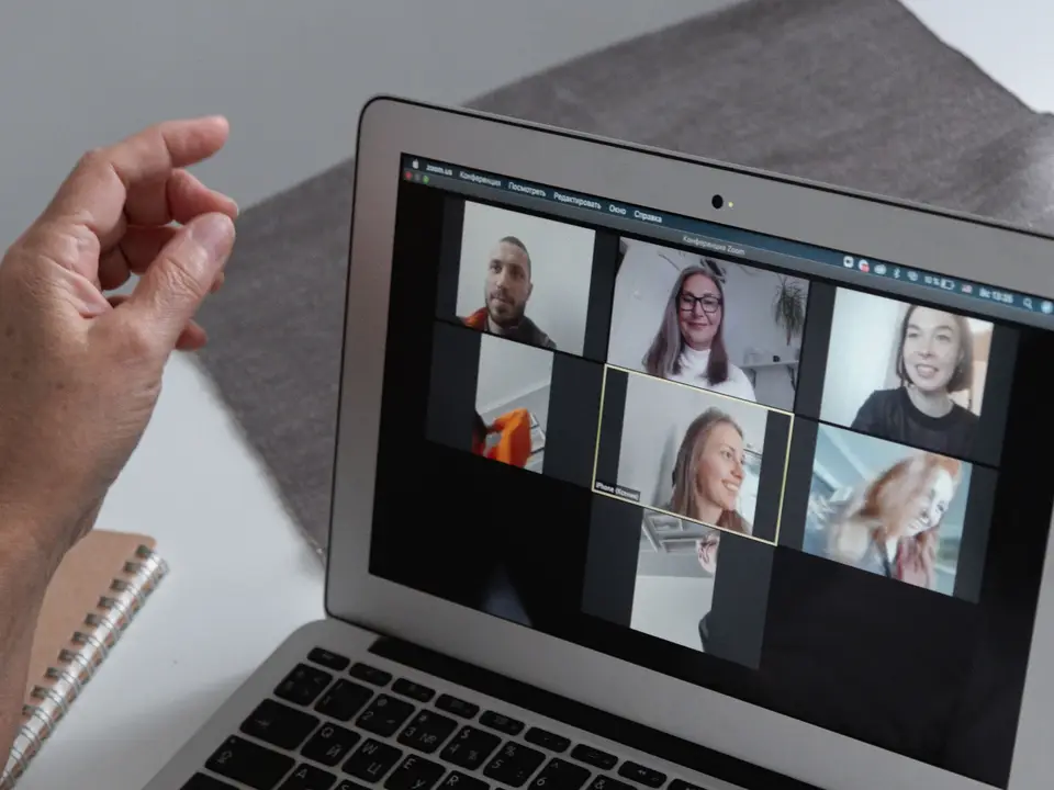 Group video call on a laptop in a home office