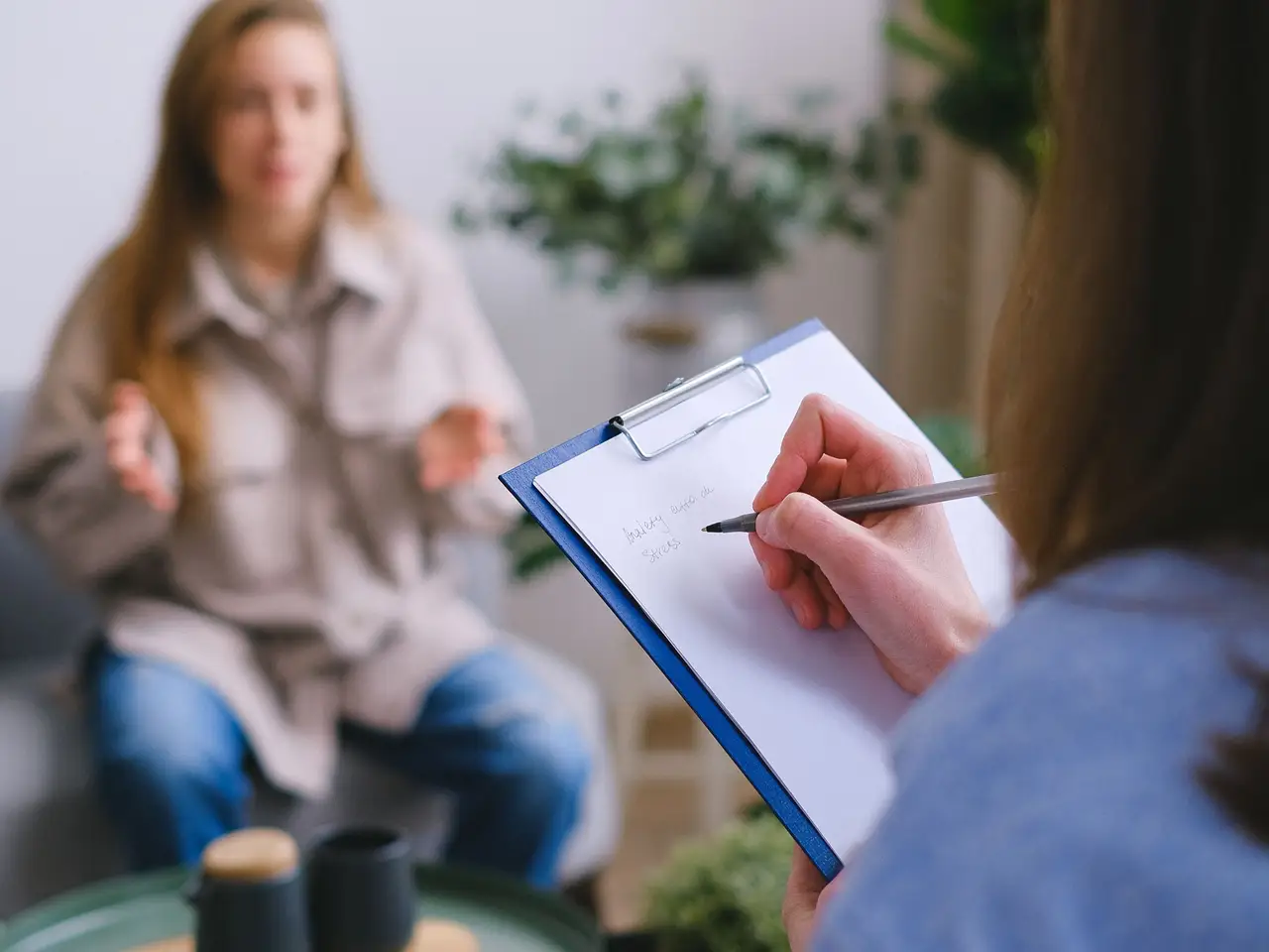 Patient on a video call with a clinician on a laptop screen.