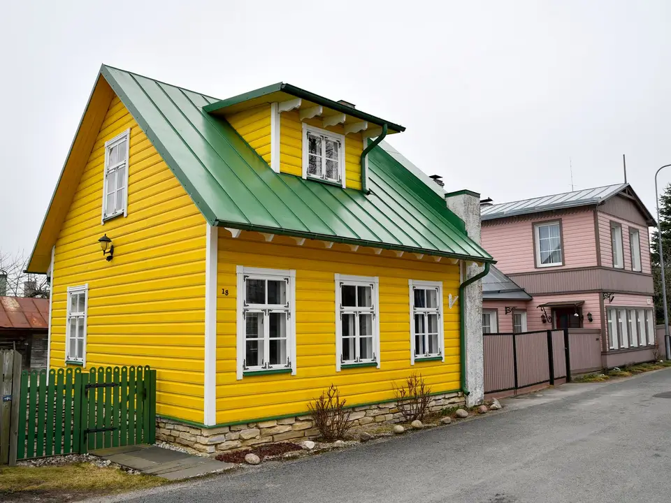 Two-story house with half the siding freshly painted