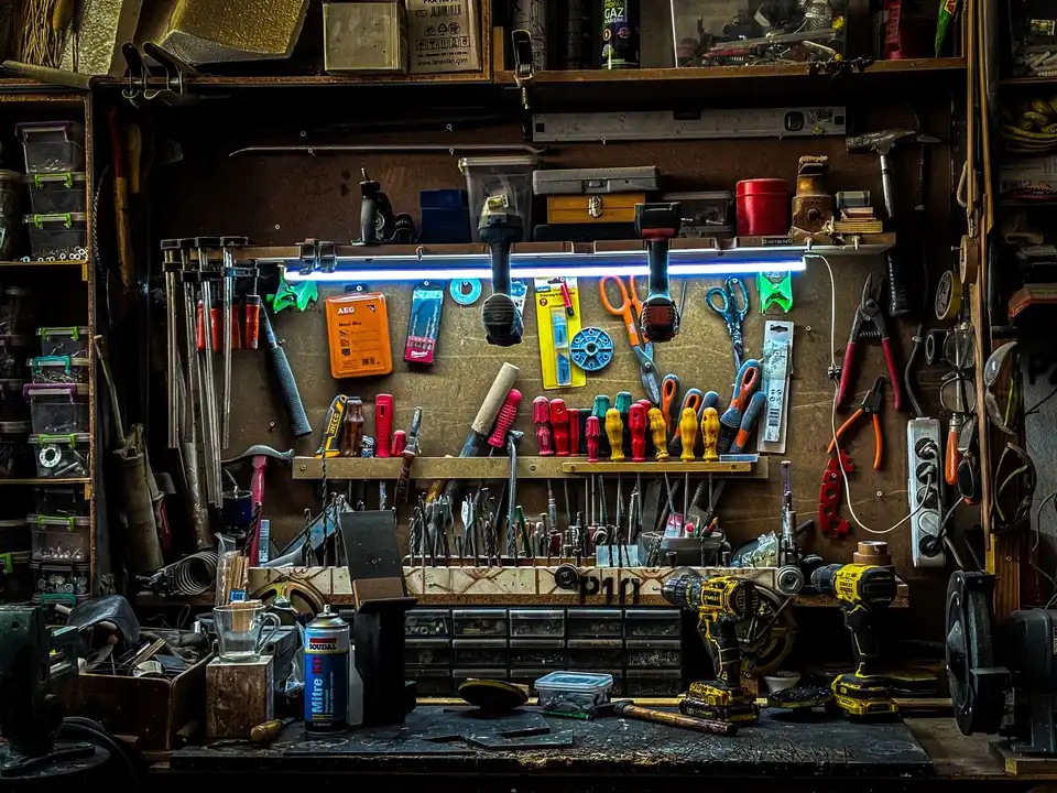 Hand tools hung on a pegboard wall