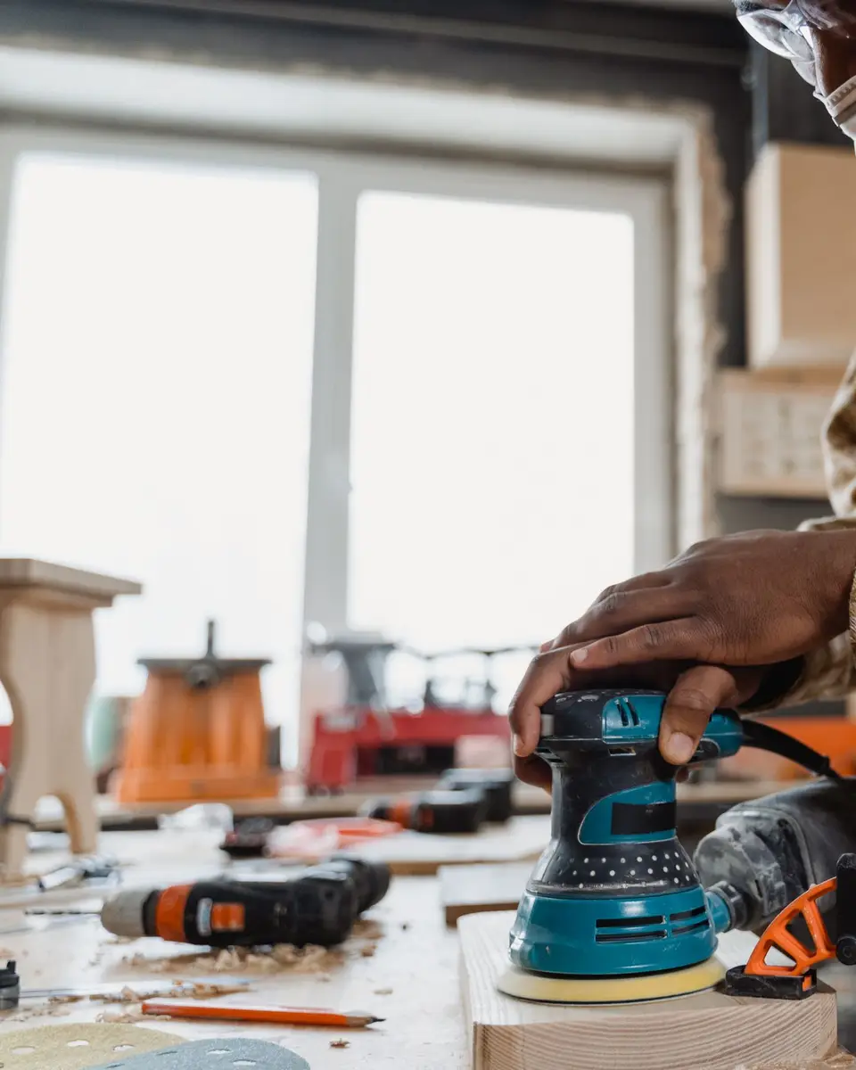 Orbital sander on a wooden board