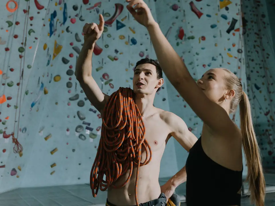 Coach briefing a climber before a bouldering attempt.