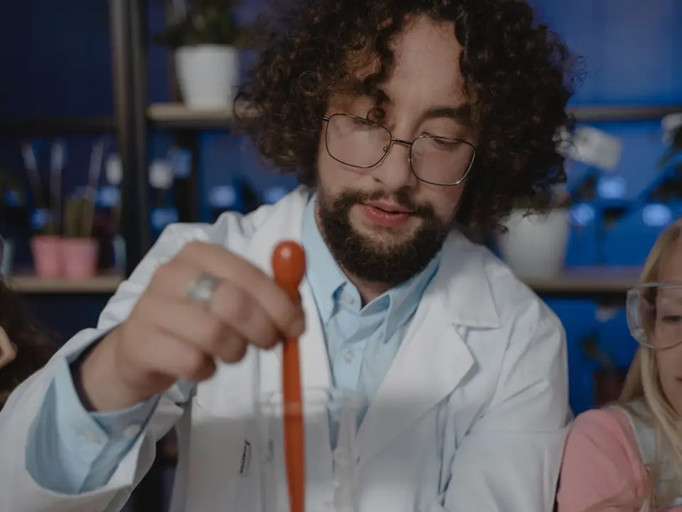 Teacher and student exploring chemistry with lab equipment