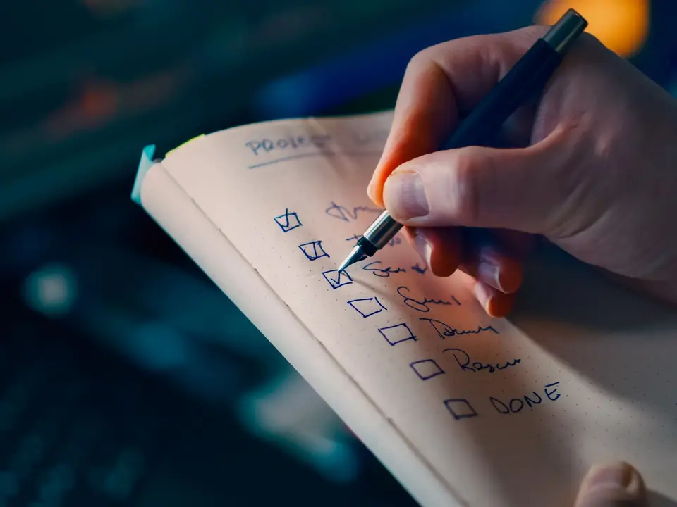 Hand writing a checklist in a notebook
