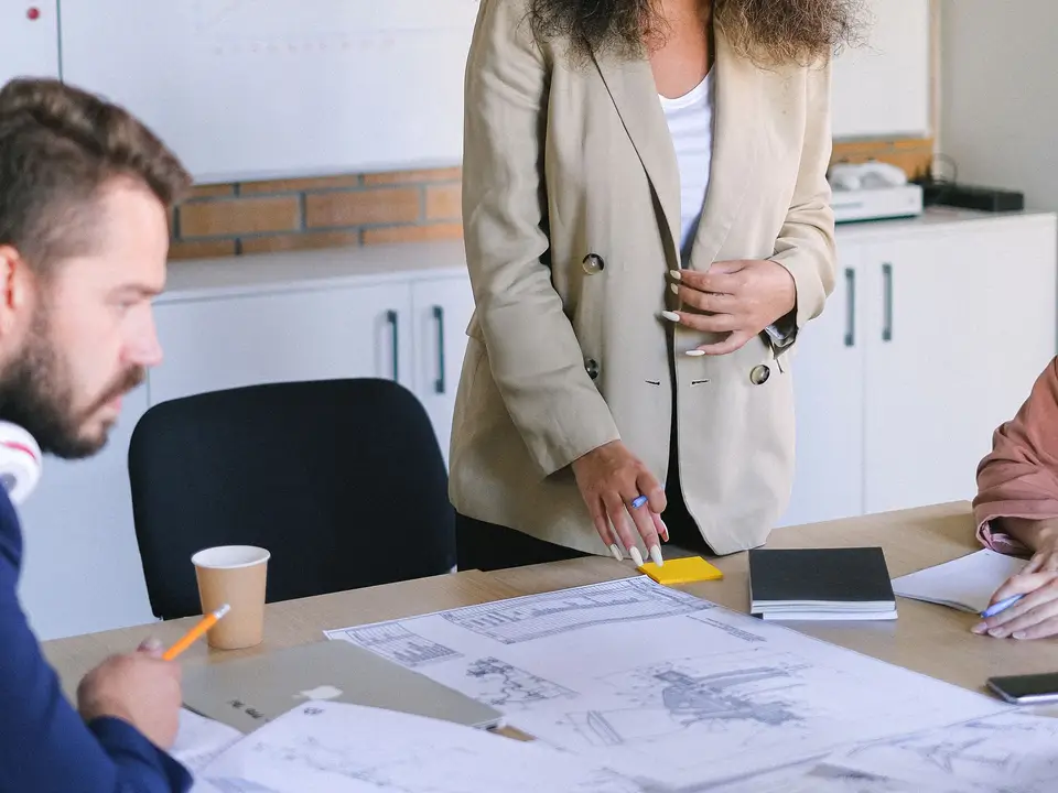 Colleagues reviewing charts and documents around a meeting table