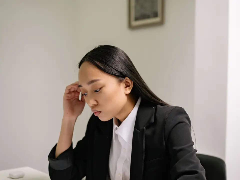 Businesswoman studying papers at her office desk