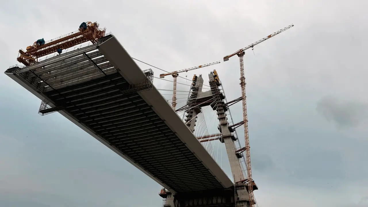 Bridge under construction with cranes working on the deck