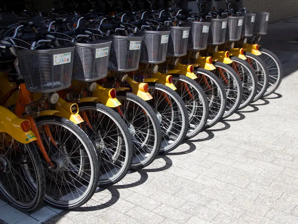 Row of shared city bikes docked on a pavement