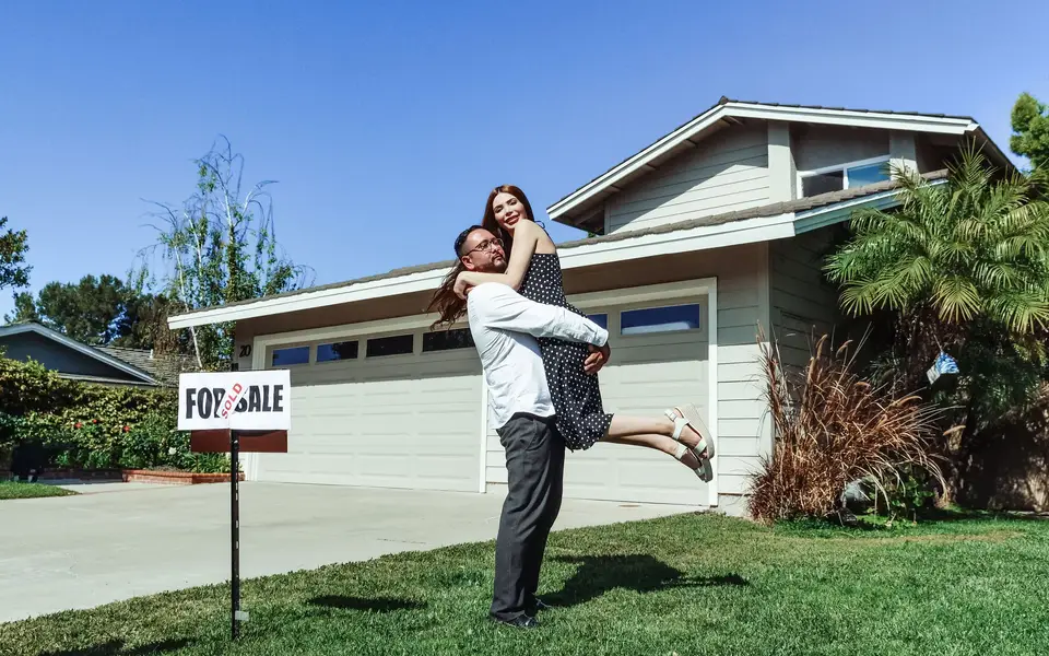 Buyer unlocking the front door of a newly purchased home