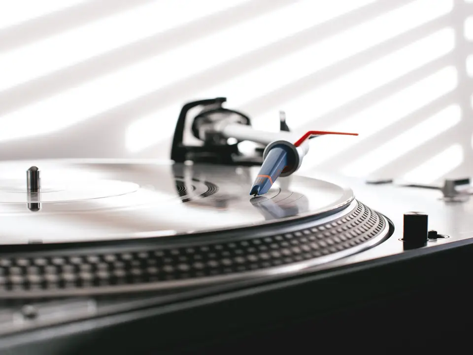Turntable needle on a spinning vinyl record seen from above