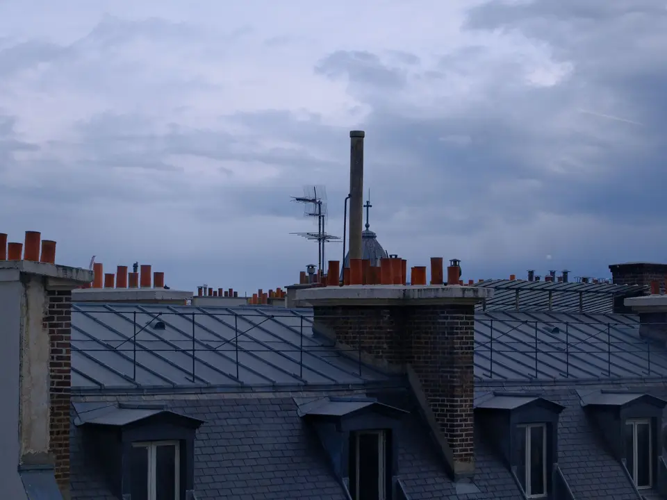 Charcoal shingle roof over a brick duplex