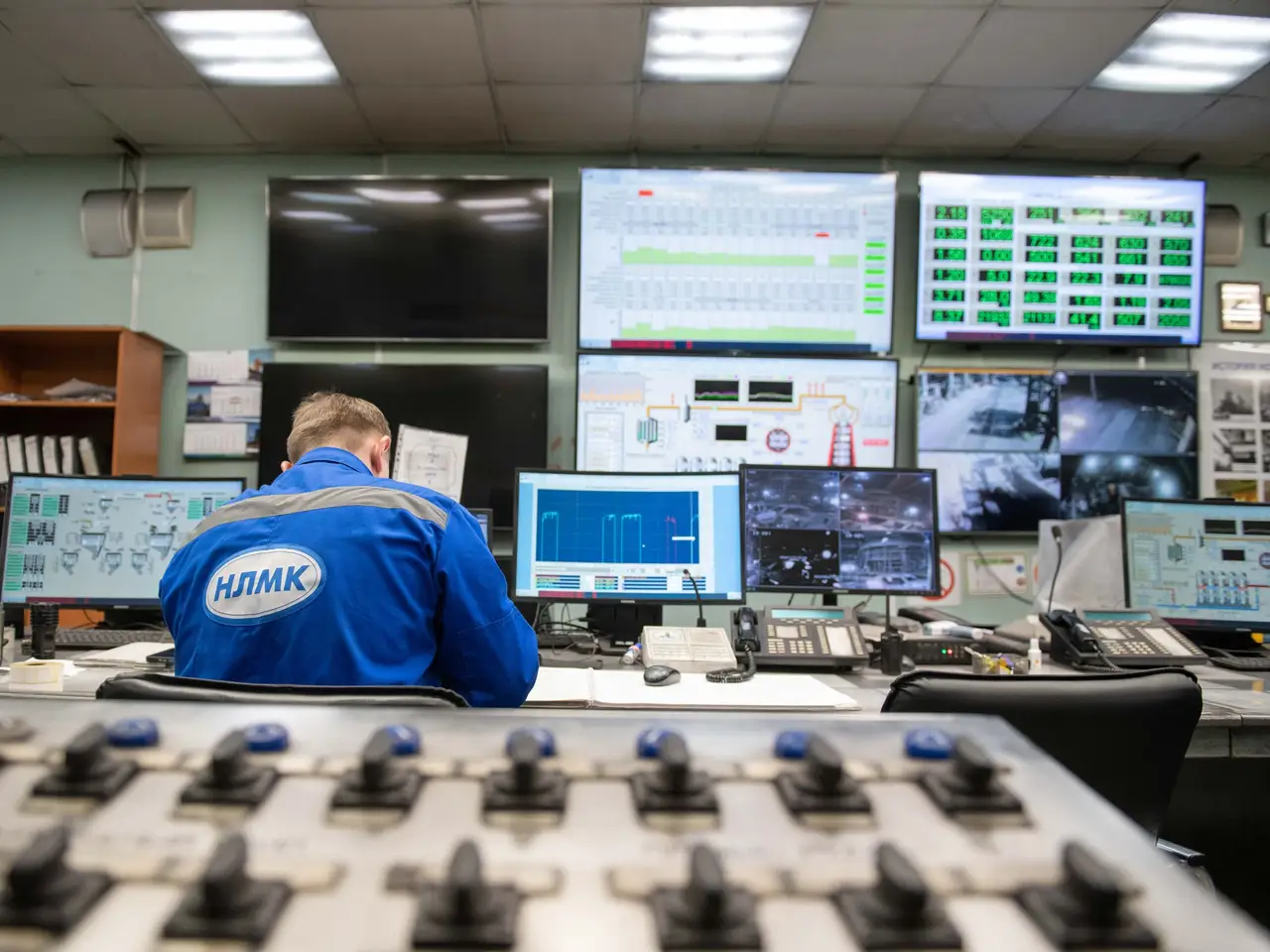 Engineer watching several monitoring screens in a control room