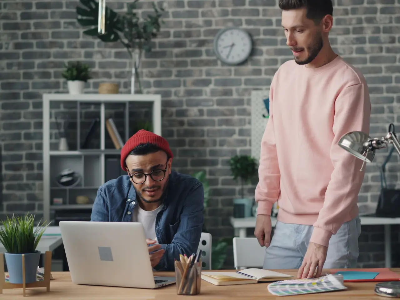 Colleagues discussing a project together in a modern office