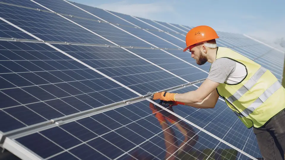 Crew installing solar panels on a rooftop
