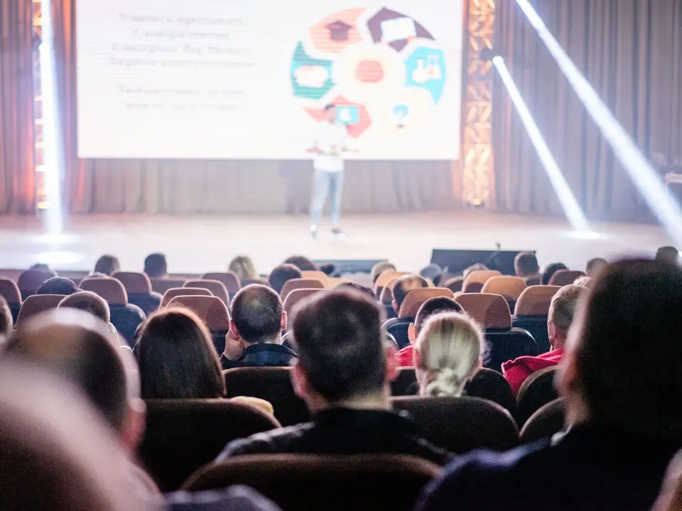 Audience seated in a large auditorium