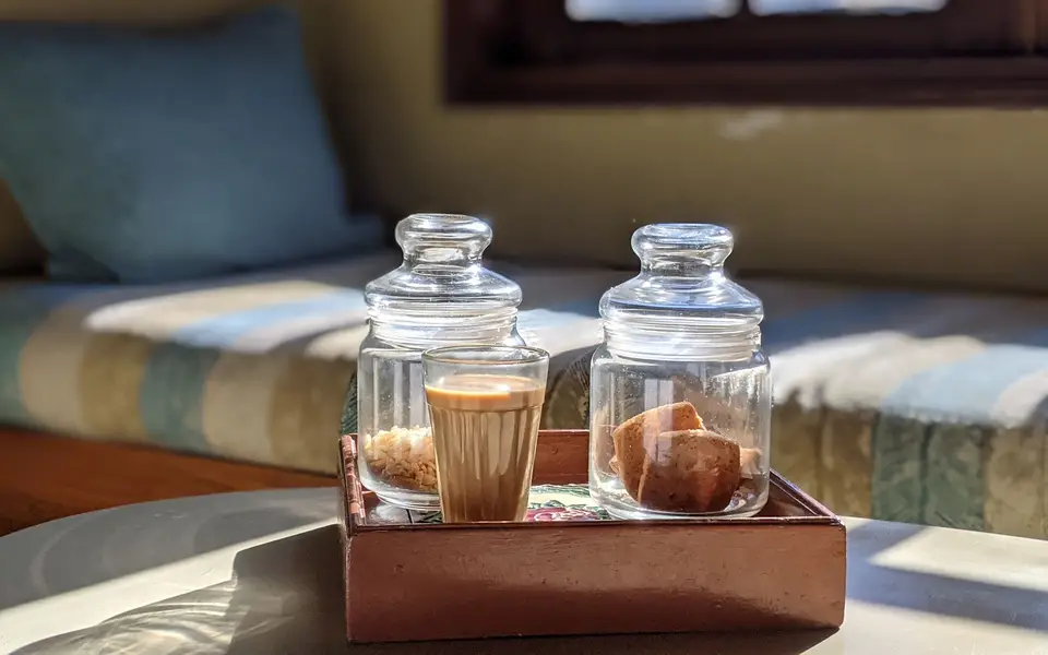 Steel glasses of chai on a tray