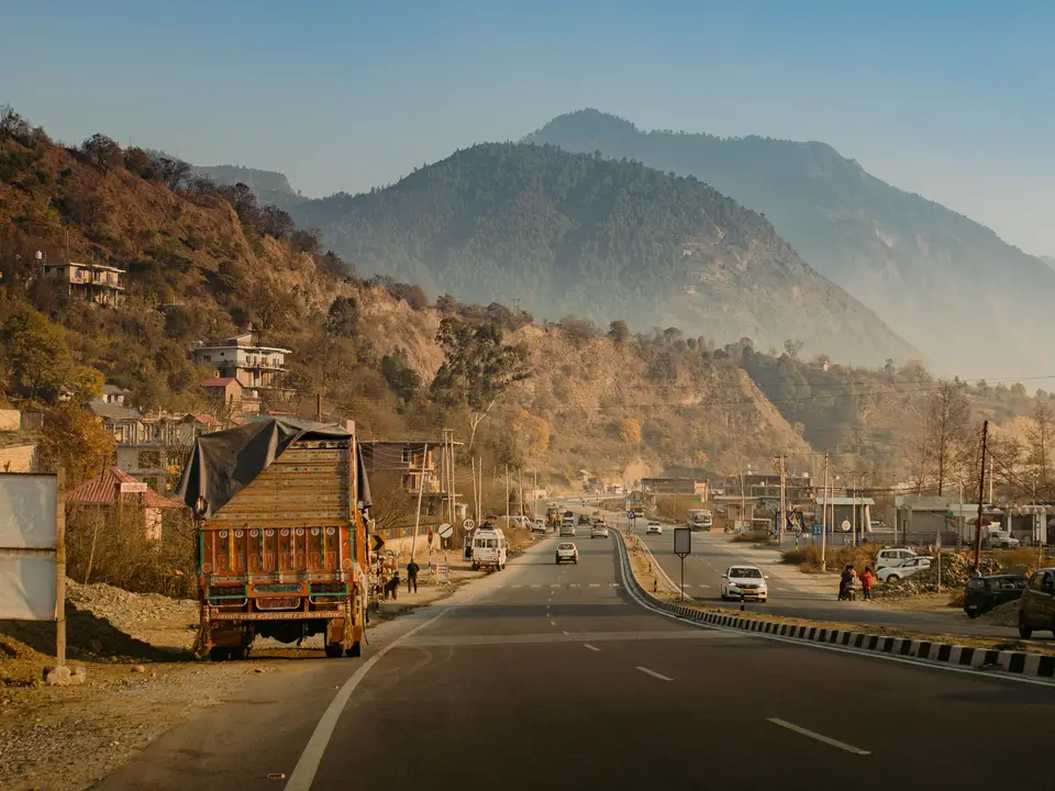 Highway with early traffic and dhaba frontage
