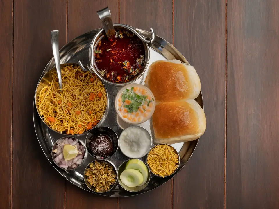 Long shared tables with steel thali sets