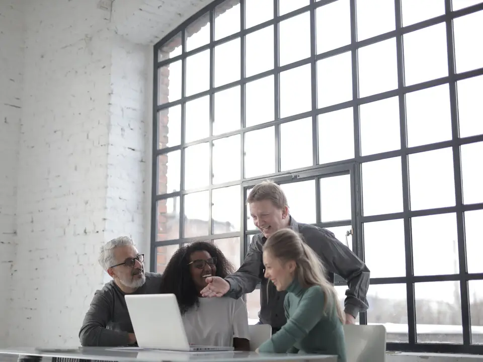 Mentor and founder talking over coffee at a window desk