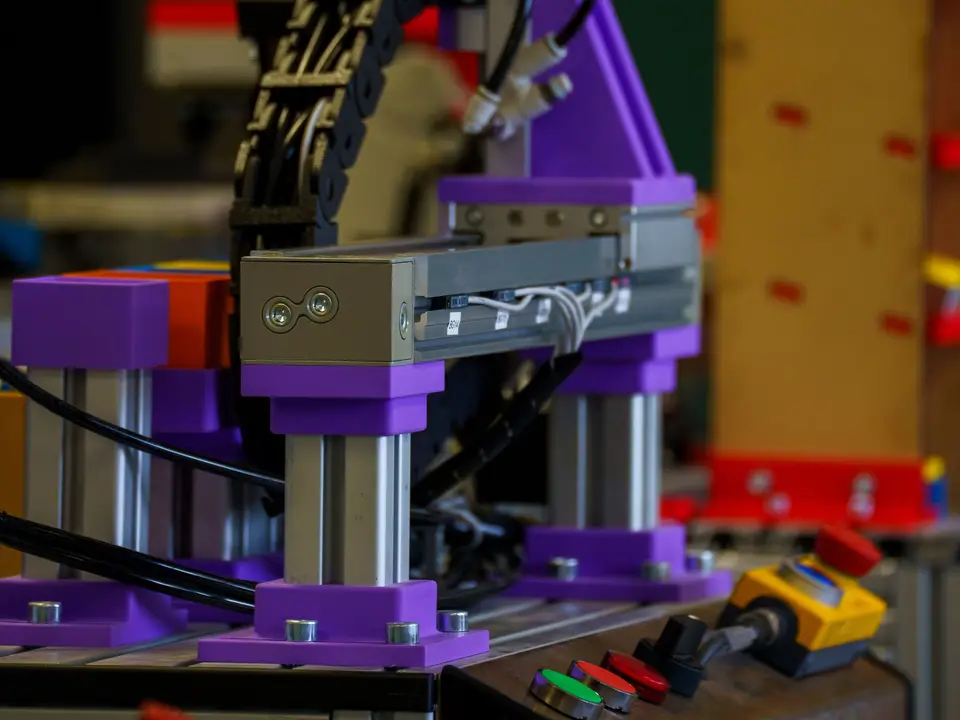 Hand guiding a robot arm wrist over a metal part
