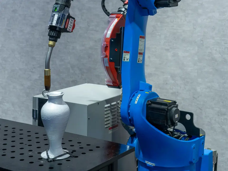 Compact robot base clamped to a wooden workbench