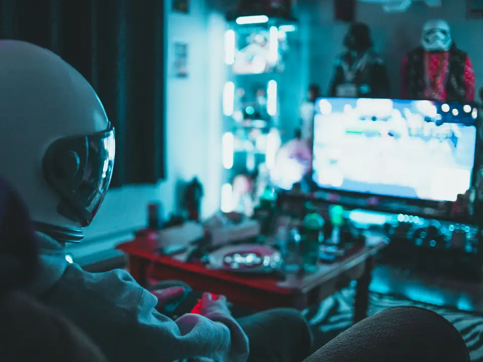Streamer corner with neon blue lighting and a cluttered monitor setup