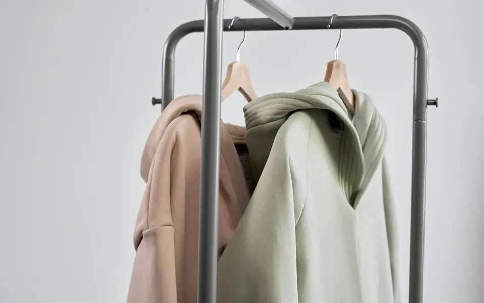 Folded streetwear hoodies stacked in a warehouse