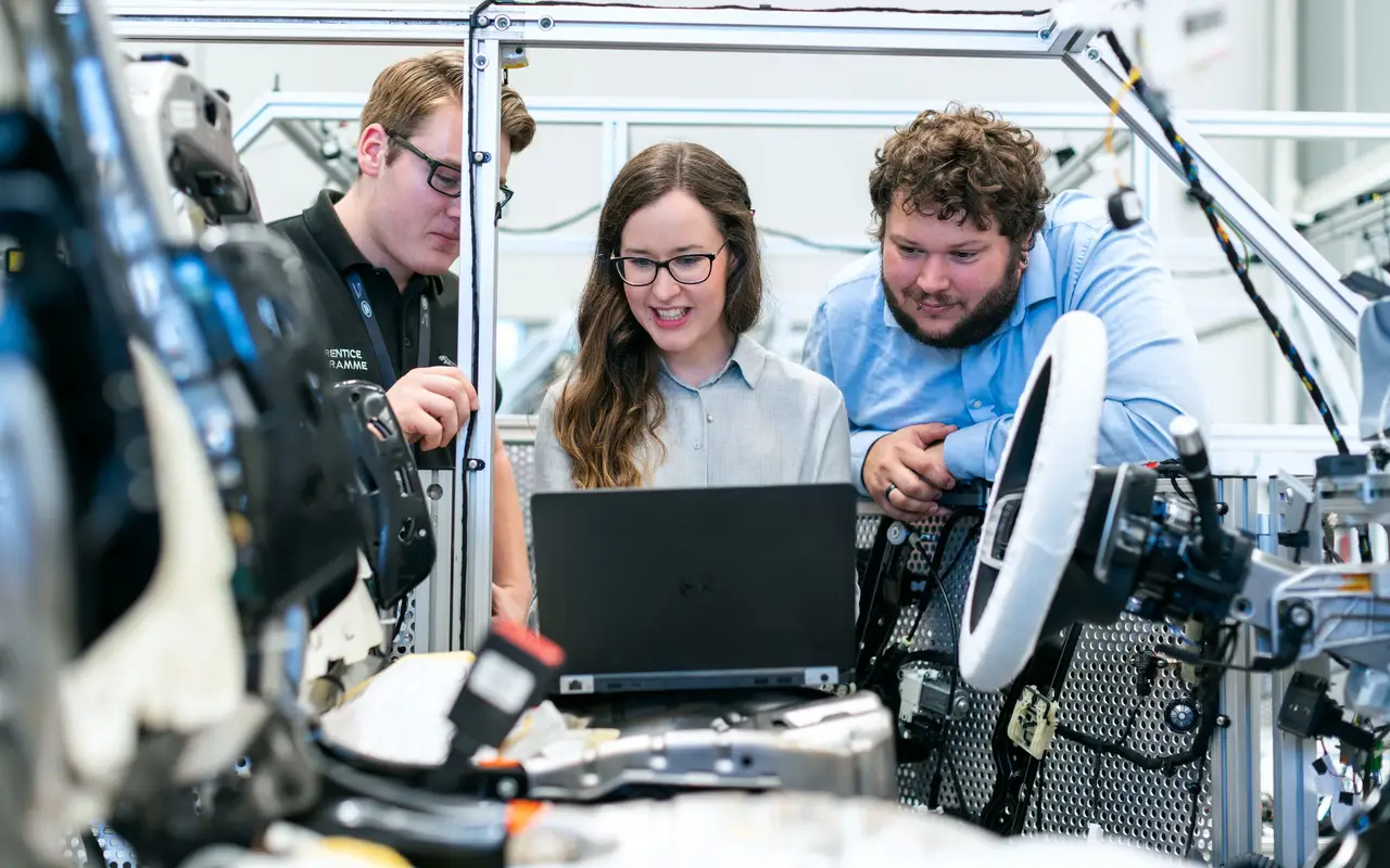 Engineering students working together on a car build