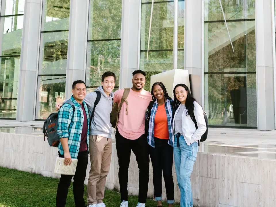Group of students outside a modern educational building