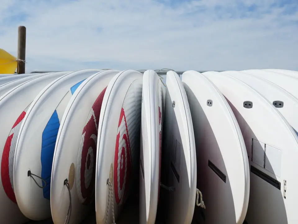 Soft-top surfboards lined up on beach