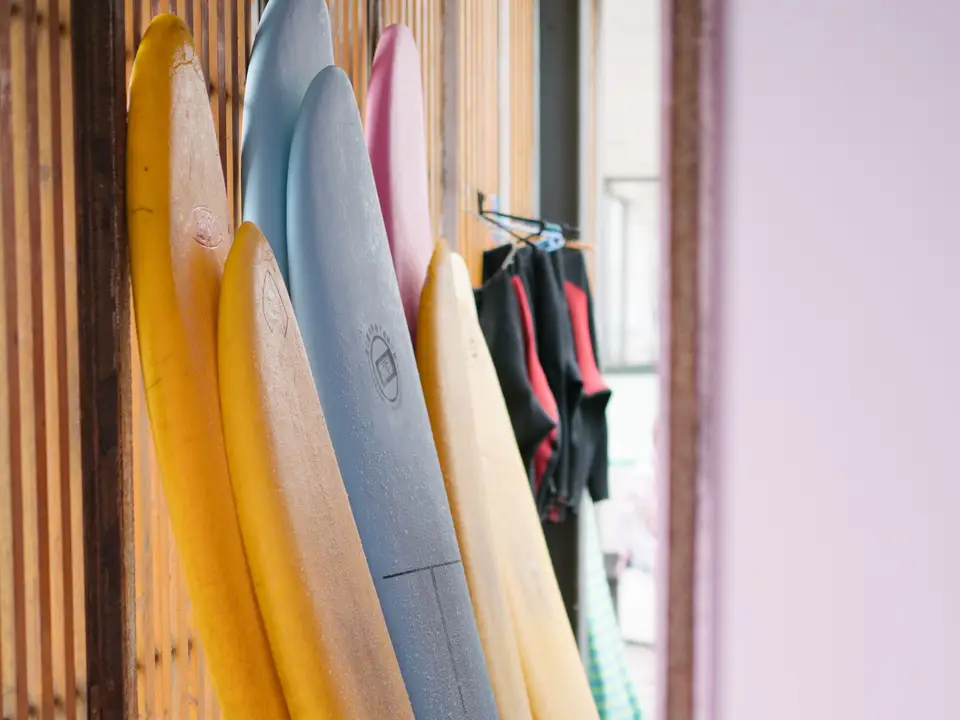Wetsuits hanging on rack