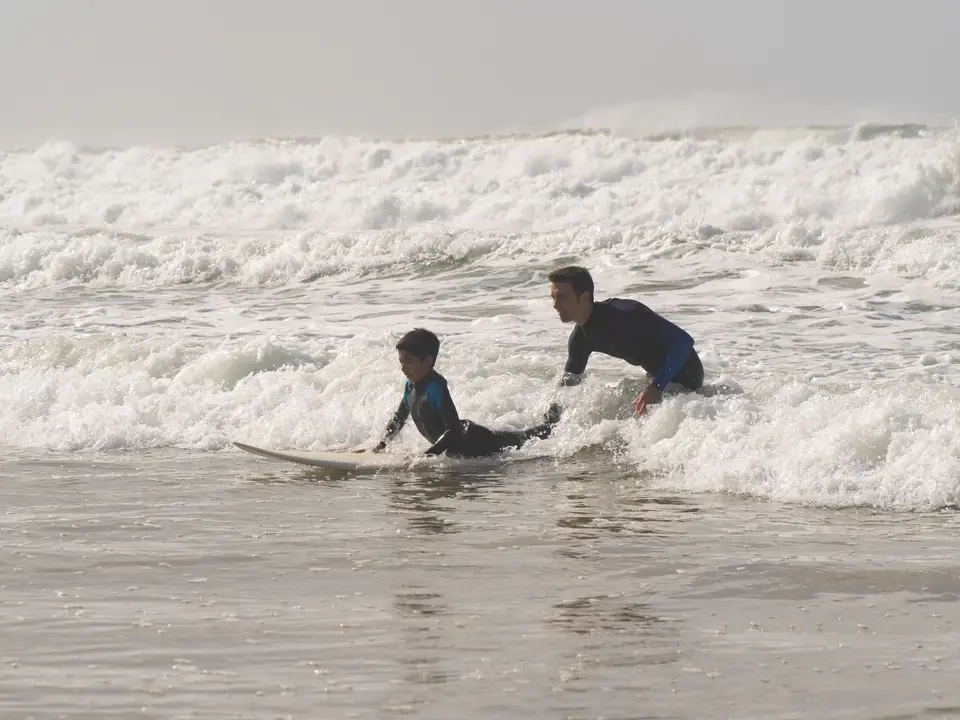 Surf coach demonstrating stance on sand