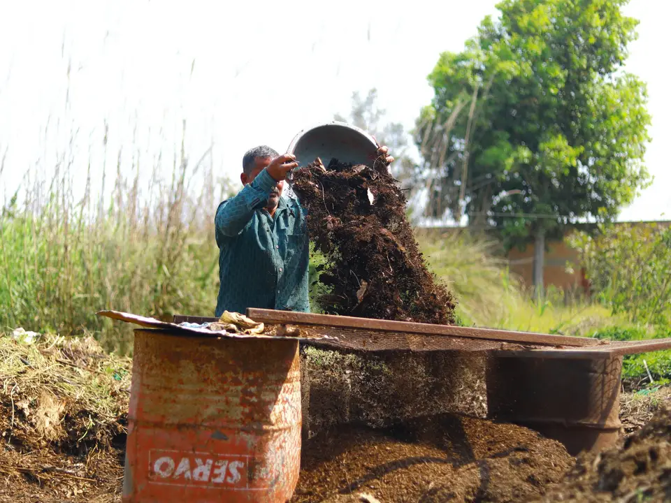 Compost pile and pitchfork at a small farm