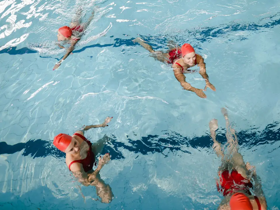 Swim instructor supporting a child in water
